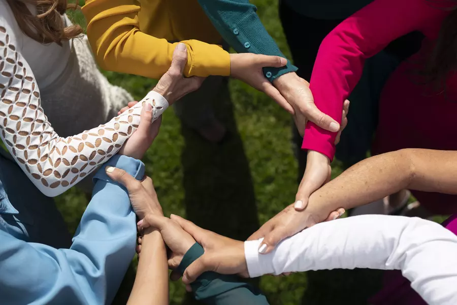 STESA Volunteers holding hands in circle